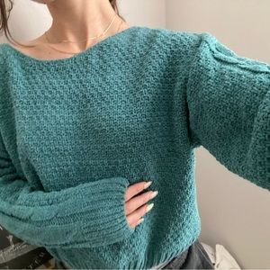 soft blue sweater with cable knit sleeves
